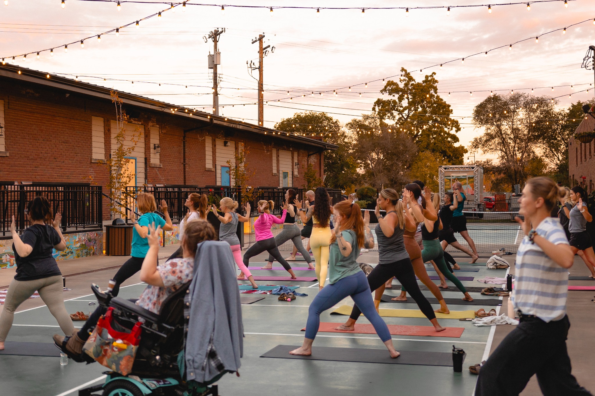 Inclusive outdoor community yoga class at sunset